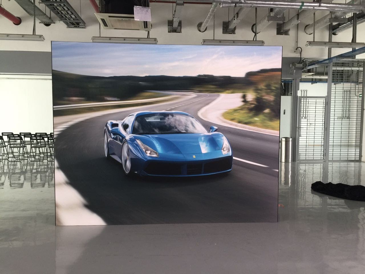 Large format Ferrari event backdrop installed in a showroom