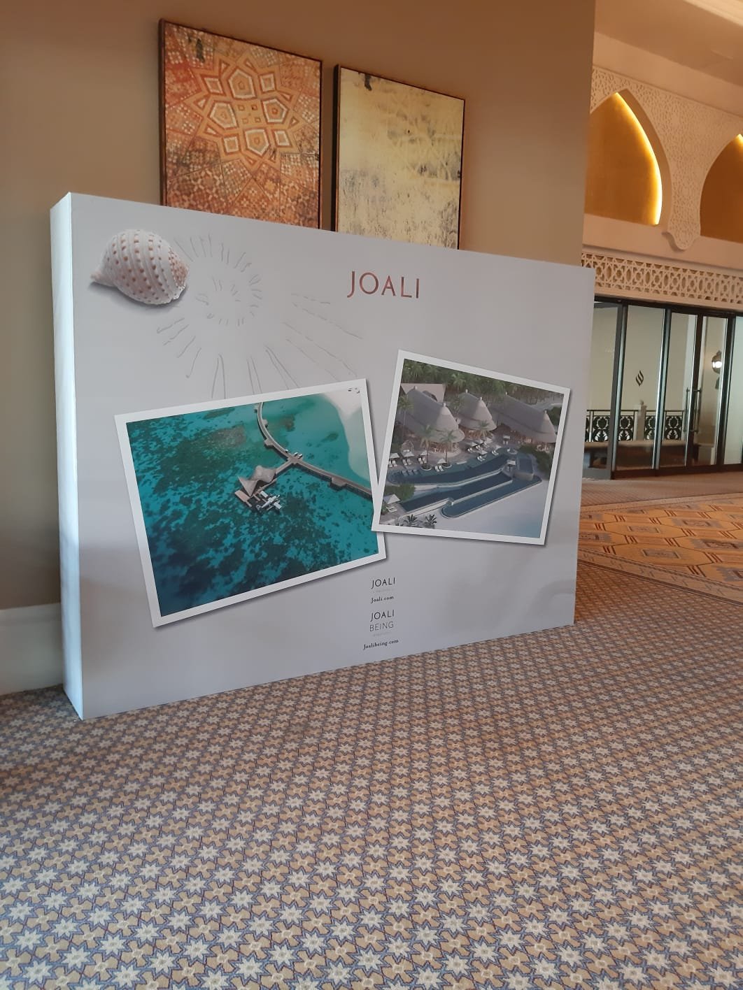 JOALI branded backdrop wall at a hotel event